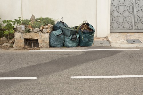 Waste management workers handling large items